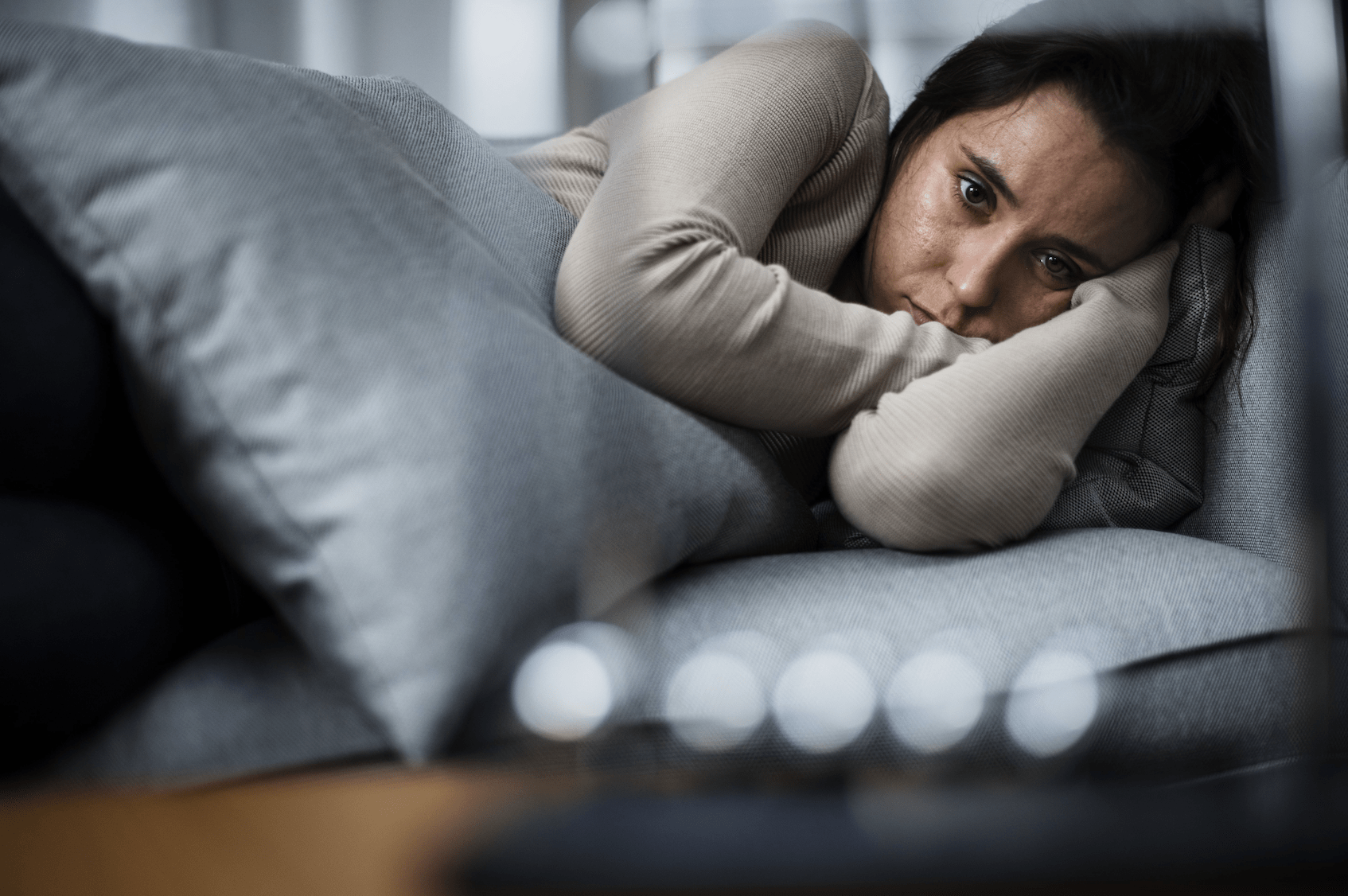 Depressed woman with pillow